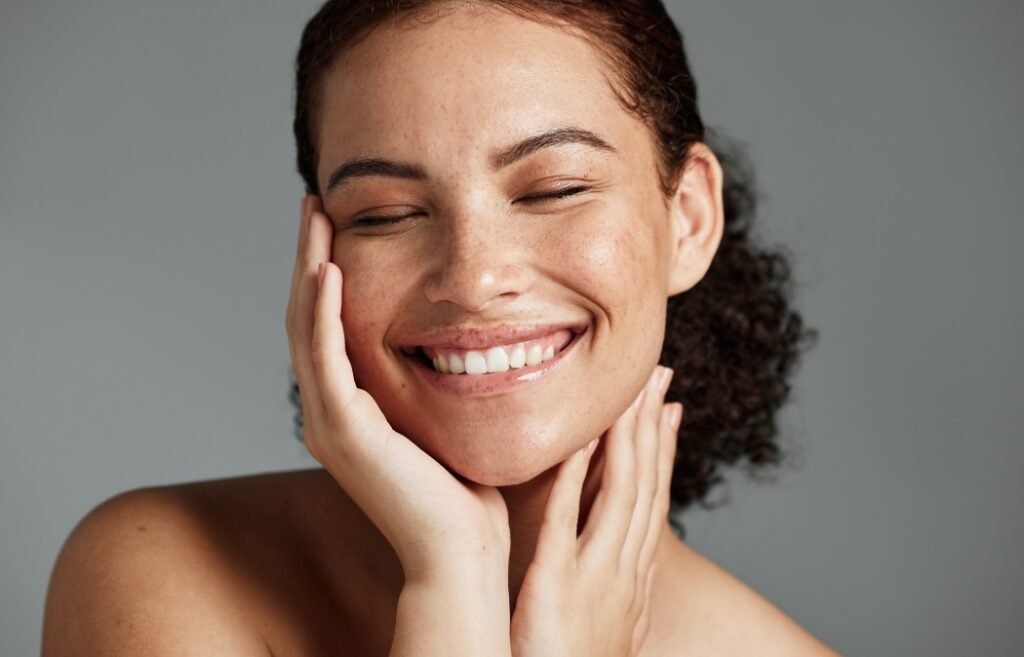 Face, beauty and satisfaction with a model black woman in studio on a gray background to promote natural skincare. Facial, wellness and makeup with an attractive young female happy with cosmetics