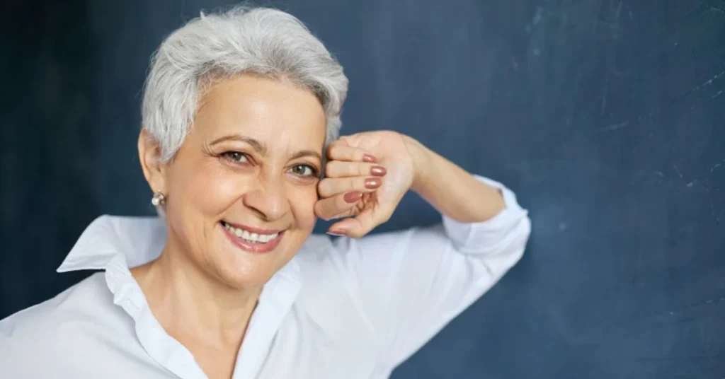 Confident woman smiling after Affordable Dentures and Implants