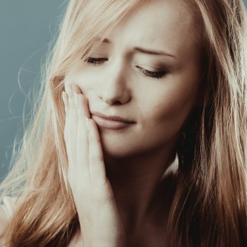 Emergency Dental Care in   Acworth woman with tooth pain discomfort