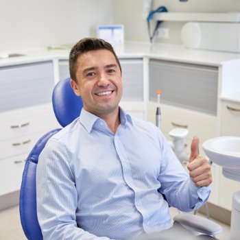 Satisfied man thumbs up in dentist chair Dental Care   Acworth
